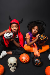 Fototapeta premium Little siblings joyfully embracing spooky fun in vibrant Halloween costumes