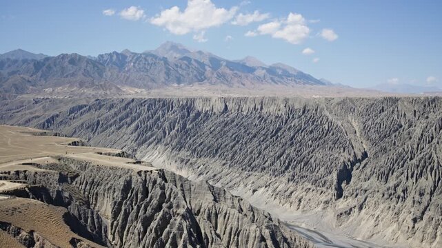 Aerial View of Dushanzi Grand Canyon and Kuitun River in Xinjiang: Winding River, Geological Formations, Mudstone Strata along Duku Highway