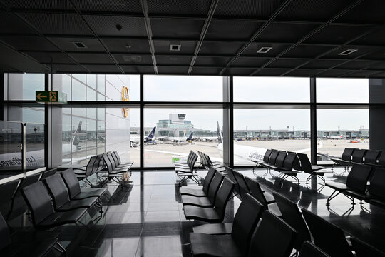 Empty airport terminal gate with planes outside