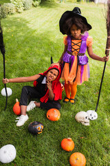 Fototapeta premium Vibrant Halloween fun with adorable siblings in colorful costumes