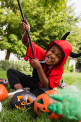 Fototapeta premium Little boy enjoying Halloween fun in a vibrant costume with spooky decorations