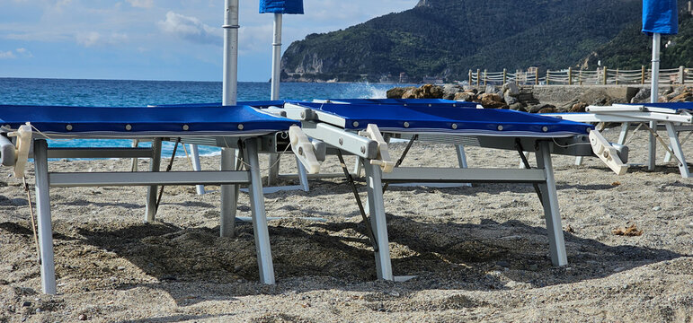Deckchairs and umbrellas at a beach resort during a summer holiday