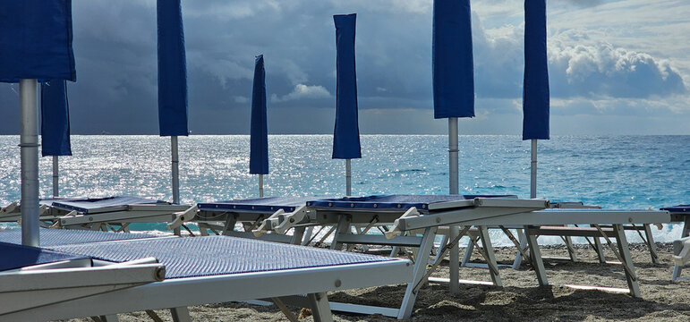 Deckchairs and umbrellas at a beach resort during a summer holiday