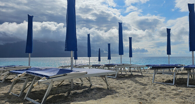 Deckchairs and umbrellas at a beach resort during a summer holiday