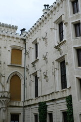 Fototapeta premium Beautiful travel stock photo of historic Hluboka castle exterior detail. Iconic hunting decor and neo-gothic architectural elements in South Bohemia for travel website layout.