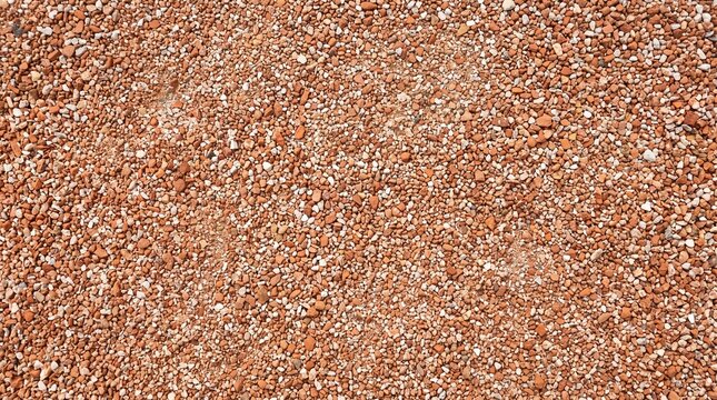 Close up texture of small brown river pebbles and smooth stones on the ground surface