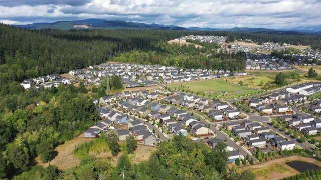 4K aerial drone footage of suburban neighborhood and residential housing in Camas, Washington, USA, showing single family homes, curved streets, real estate development and community layout