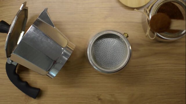 Adding Ground Coffee to a Moka Pot for Coffee Brewing