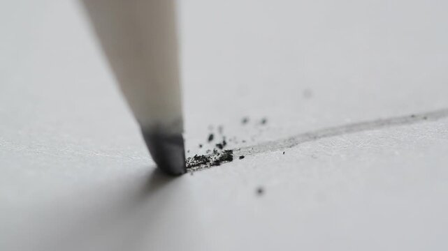 Pencil draw line on white paper sheet drafting creative sketch or technical plan in 4K Ultra HD footage.
