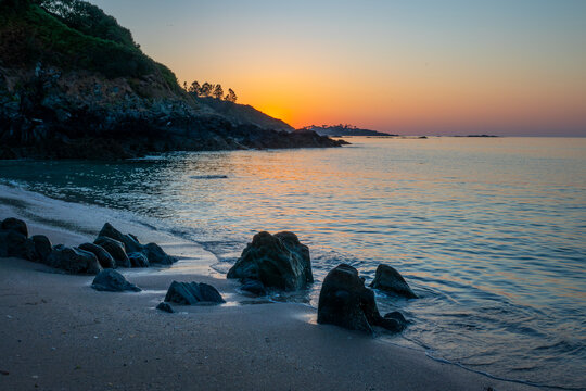 View of rocks on Beg Douar beach at sunset near Lannion, C&ocirc;tes d'Armor, Brittany landscape, France