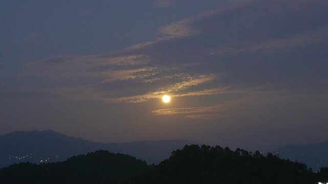 Slow Zoom Toward Low Sun Glowing Through Layered Clouds Over Berinag Hills, Uttarakhand