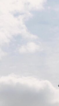 Animation of stone sculpture over sky with clouds