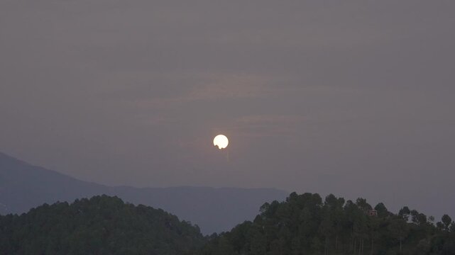 Low Sun Glowing Through Haze Over Layered Kumaon Hills near Berinag and Chaukori, Uttarakhand