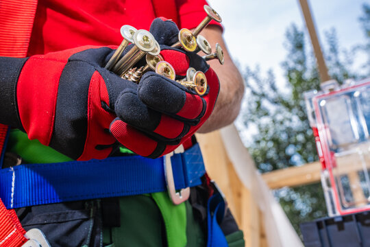 Holding screws at a construction site in daytime