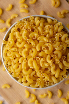 Dry Organic Elbow Macaroni Pasta in a Bowl, top view.