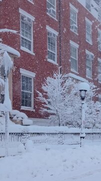 New York City during a winter blizzard. Row of 19th century townhouses in Greenwhich Village Washington Square Park, Manhattan, under heavy snowfall