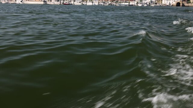 Waves and Wake Created by a Speedboat Moving Across the Sea
