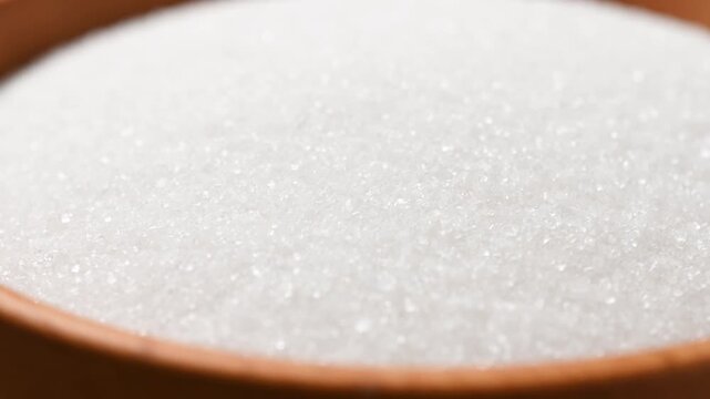 Wooden bowl of white sugar. Close up