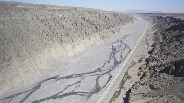 Panoramic Aerial View of Dushanzi Grand Canyon and Kuitun River in Xinjiang: Winding River, Geological Formations, Mudstone Strata along Duku Highway