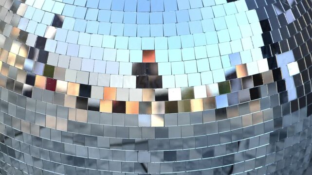 Disco ball with shiny mirror tiles reflecting lights for party background