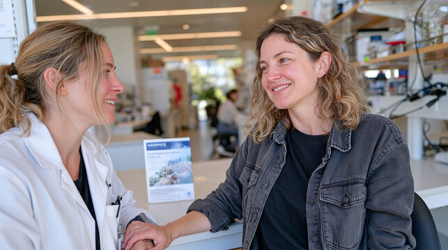 A pathology laboratory with warm overhead lighting stretches wide in an establishing shot, an end-of-life doula speaking softly to a pathology technician near specimen storage, a hospice brochure pl