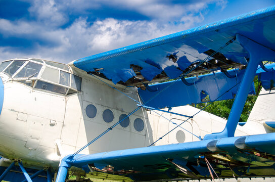 Vintage trainer aircraft parked in a row during an outdoor aviation exhibition.  Historical military planes on public display at an open air aviation museum. Old aircraft collection plane in daylight