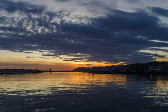 Sunset silhouette Imperia coastal city, Italy