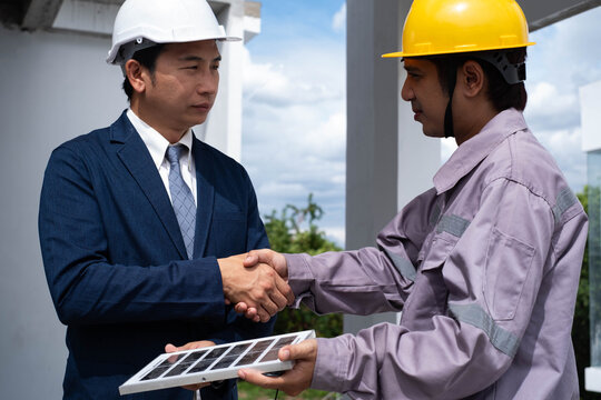Professional engineer and construction worker shaking hands at a building site, symbolizing teamwork, project management, safety, quality inspection, successful collaboration, construction industry.