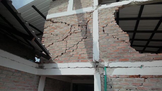severely cracked brick wall and structural damage after colombia earthquake