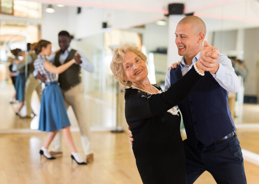Man and mature woman learning to dance classical ballroom dance