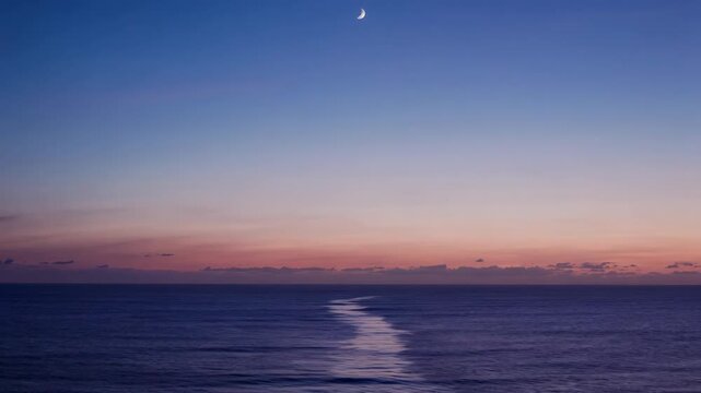 A vibrant night sky over a tranquil ocean.