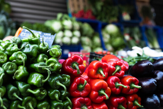 Pile of bell peppers displayed on market counter