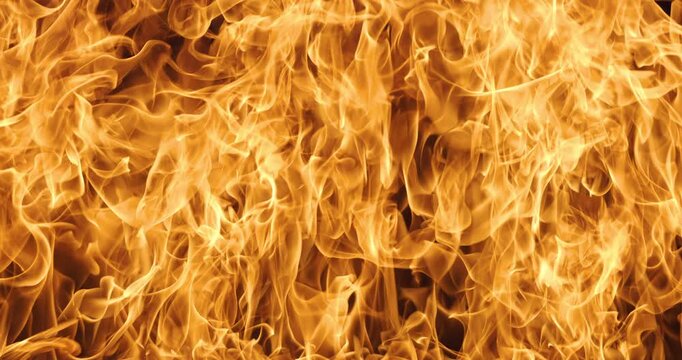 Abstract orange flames with smoke on black background.