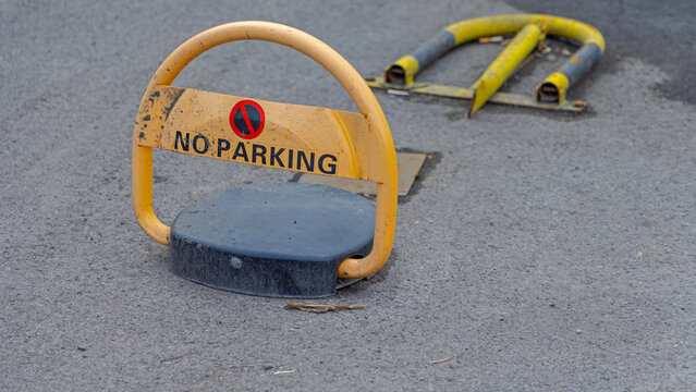 No Parking Sign at Yellow Remote Controlled Automatic Parking Barrier Lock Secured Space