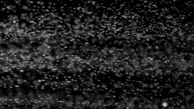 Floating abstract particle bokeh on dark background. Shot on super slow motion camera 1000 fps.