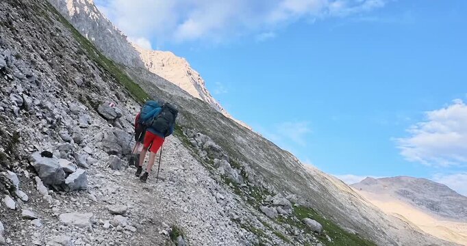 Hikers crossing rocky alpine terrain on the Gatterl route