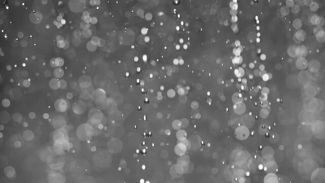 Floating abstract particle bokeh on dark background. Shot on super slow motion camera 1000 fps.