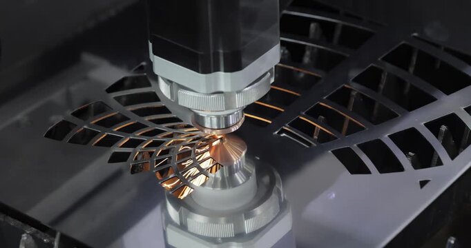 Industrial CNC laser cutting machine with flying sparks in metal fabrication.