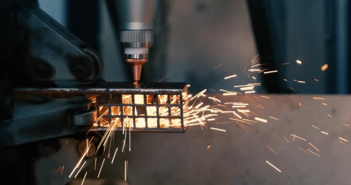 CNC Laser cutting of metal, modern industrial technology Making Industrial Details. Shot on super slow motion camera 1000 fps.