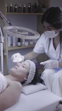 Meticulous facial care applied beneath a glowing ring light