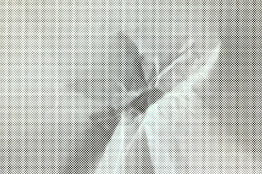 Portrait of a man constructed from numerous tiny dots creating a halftone effect