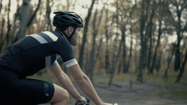 Cyclist Riding Road Bicycle Along Forest Park Trail In Autumn. Cycling Training