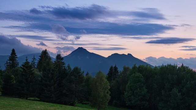 Majestic Mountain Peak Sunset Timelapse with Dusk Clouds and Forest Silhouette