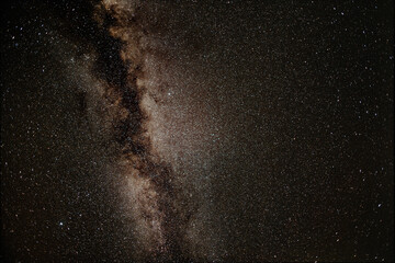 Milky way galaxy band creating a dramatic celestial spectacle across a dark, star-filled night sky, capturing the vastness of the universe and deep space astronomy © Arthur