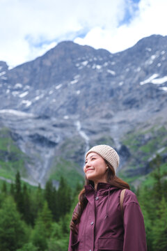 Vertical portrait image of a woman with mountain range in summertime, Chengdu, China