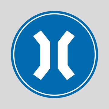Blue circular mandatory traffic sign with two white diverging arrows, indicating traffic must pass on either side of an obstacle.