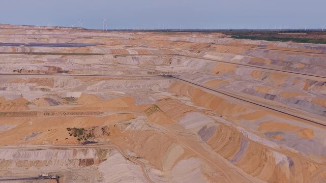 Huge open pit lignite coal mine with wind turbines