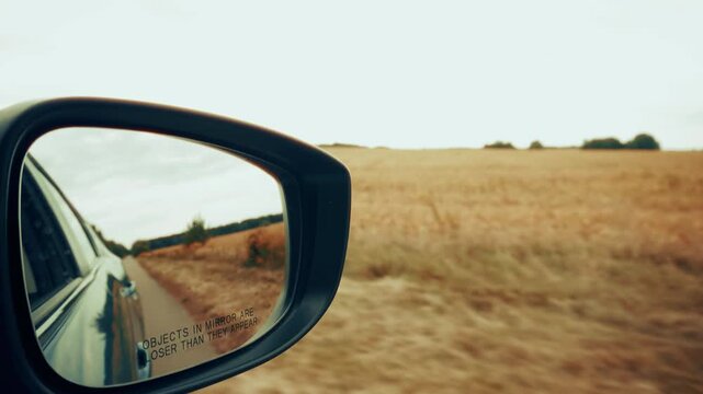Car Driving Fast Along Open Rural Field Highway