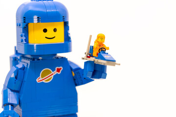 Fototapeta premium Hong Kong, June 8, 2026: A giant blue spaceman holds a tiny spacecraft, symbolizing future discovery and space exploration plans.