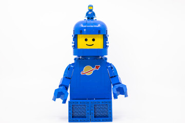 Fototapeta premium Hong Kong, June 8, 2026: A giant classic spaceman strides forward, carrying a tiny companion perched atop his helmet.